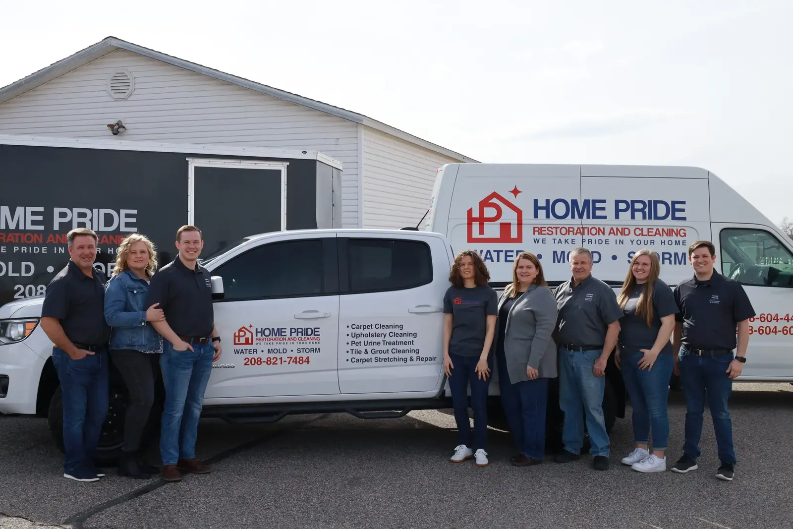 Reconstruction Services - Our team next to our vehicles in Idaho Falls - Home Pride Restoration